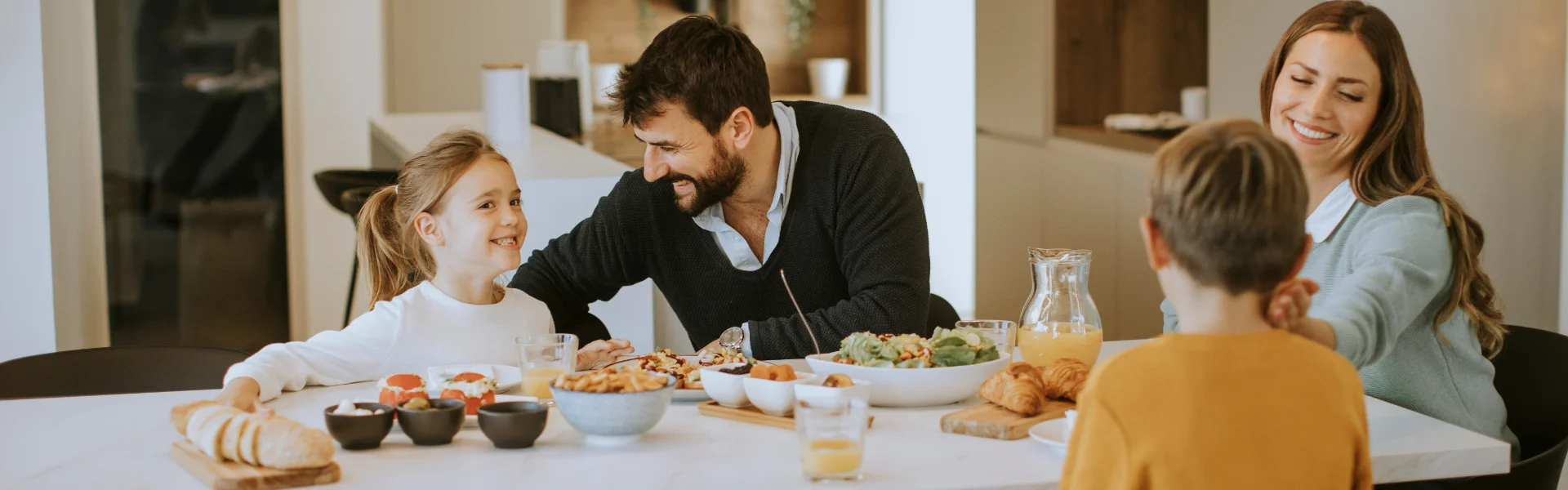 Family enjoying a meal in their Vancouver WA residential home, protected by Deep Roots Pest.
